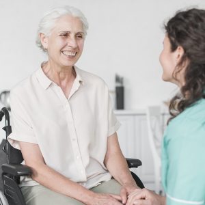 WEB-nurse-looking-at-female-senior-patient-on-wheel-chair